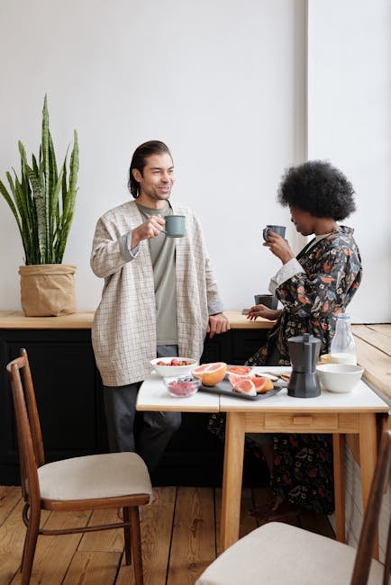 A cheerful couple enjoying morning coffee together with a healthy breakfast and cozy atmosphere.